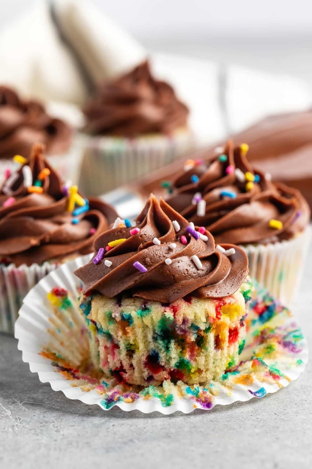 Birthday cake cupcakes with chocolate frosting and colorful sprinkles