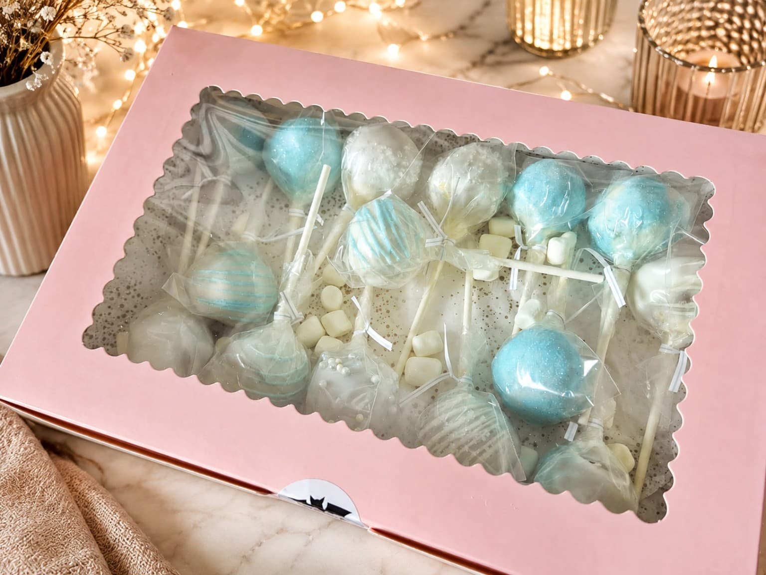 Blue and white cake balls in a pink gift box