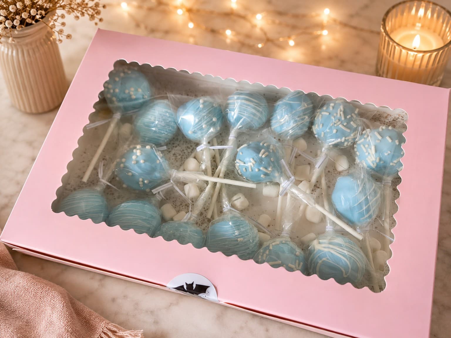 Blue and white cake pops in a pink gift box